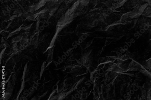 abstract background of a crumpled sheet of black paper 