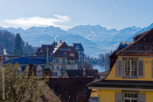 Panoramic landscape with skyline of City of Thun and Aare River and Swiss Alps in the background on a sunny winter day. Photo taken February 21st, 2023, Thun, Switzerland.