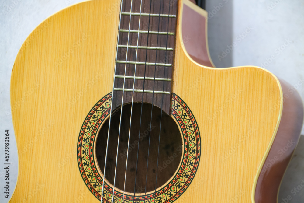 Acoustic guitar on a white background, close-up of photo