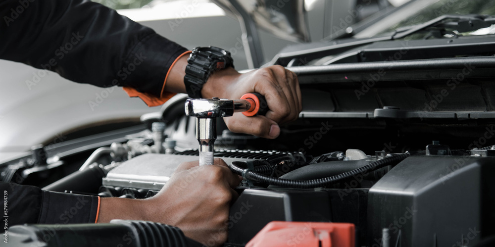 Mechanic fixing a car at home. Repair and service. Mechanic fixing a car at home. Repair and service.