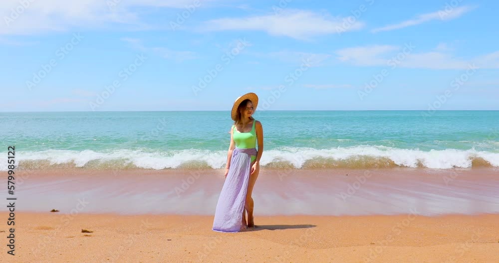 Attractive woman in swimwear on the beach or ocean, relaxes on vacation, calm and serenity of the exotic location. Smiling girl in a straw hat enjoying sunshine and leisurely of tropical getaway Attractive woman in swimwear on the beach or ocean, relaxes on vacation, calm and serenity of the exotic location. Smiling girl in a straw hat enjoying sunshine and leisurely of tropical getaway