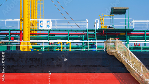 Fotografie Background of Oil pipeline system with gangway accommodation ladder of red and b