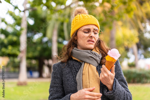 Brunette woman with a cornet ice cream at outdoors
