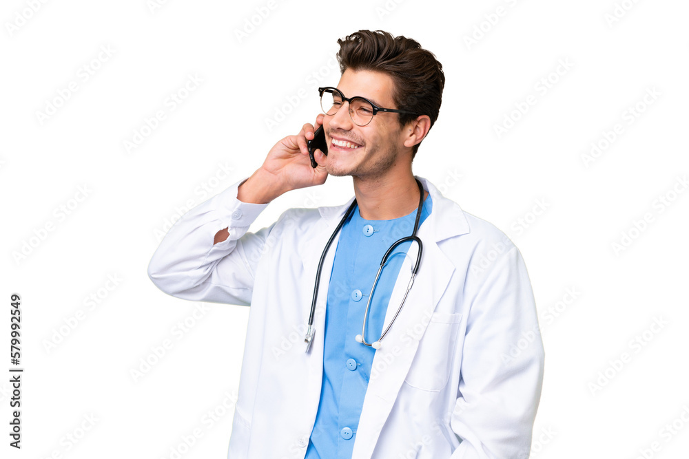 Young doctor man over isolated background keeping a conversation with the mobile phone Young doctor man over isolated background keeping a conversation with the mobile phone