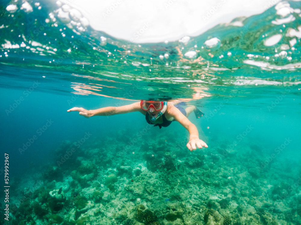 woman snorkeling in clear tropical sea
