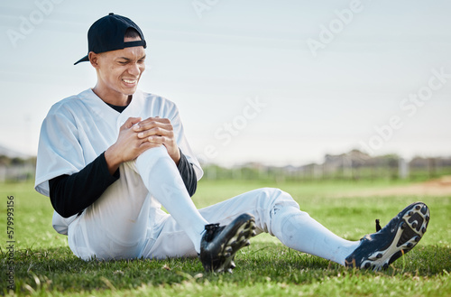 Baseball, pain and man with knee injury on field after accident, fall or workout in match. Sports, training and male athlete with fibromyalgia, inflammation or broken leg, arthritis or tendinitis.