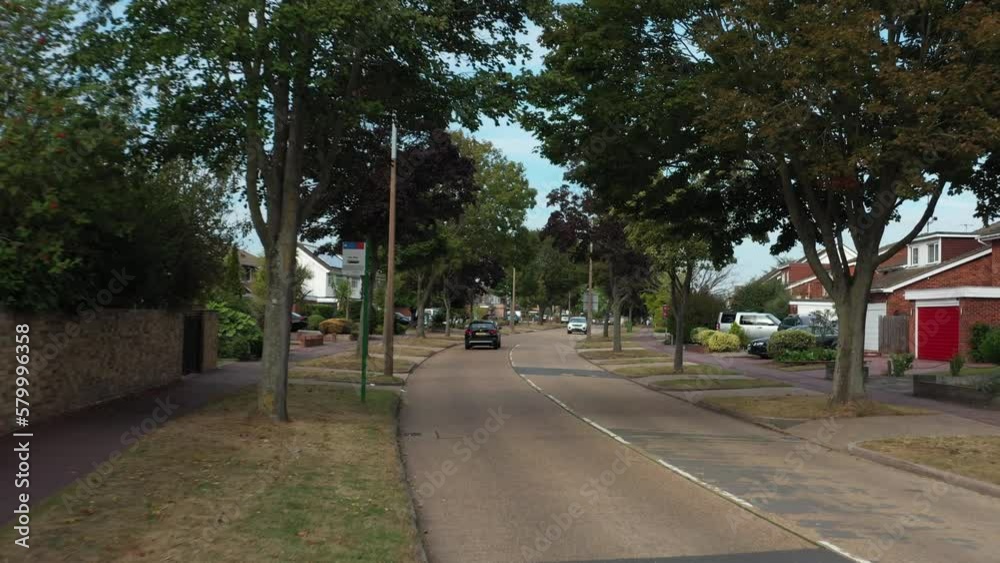 low angle zoom in view car driving on the road in united kingdom neighborhood low angle zoom in view car driving on the road in united kingdom neighborhood
