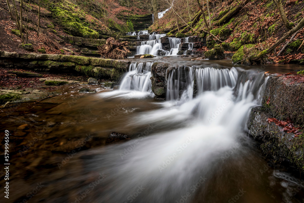 Obraz premium Beautiful dramatic landscape image of Scaleber Force waterfall in Yorkshire Dales in England during Winter morning