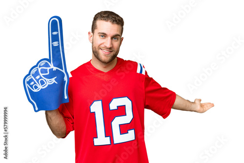 sports fan man over isolated chroma key background extending hands to the side for inviting to come