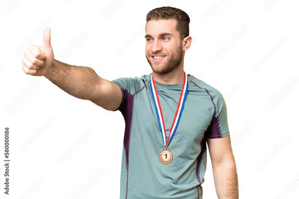 Young handsome blonde man with medals over isolated chroma key background giving a thumbs up gesture Young handsome blonde man with medals over isolated chroma key background giving a thumbs up gesture