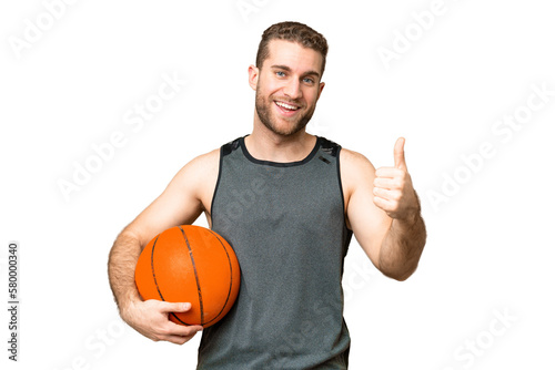 Handsome young man playing basketball over isolated chroma key background with thumbs up because something good has happened