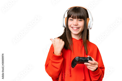 Little caucasian girl playing with a video game controller over isolated background pointing to the side to present a product