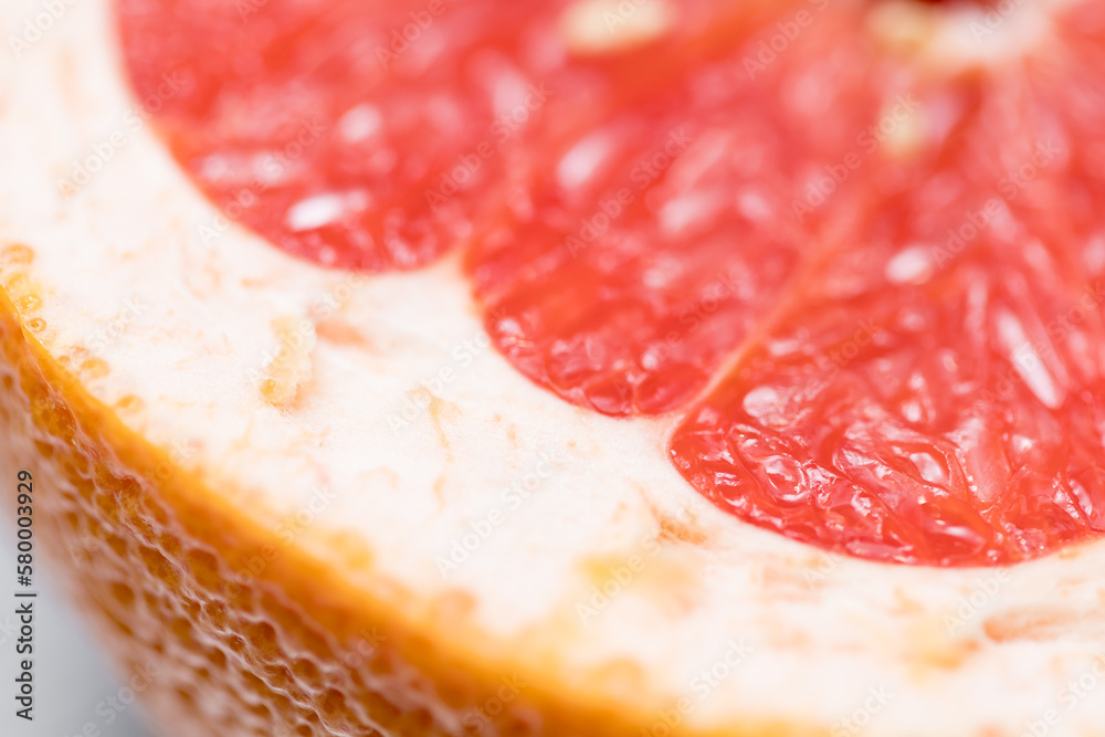 Defocused blurred cut grapefruit macro texture close up with orange grapefruit skin Defocused blurred cut grapefruit macro texture close up with orange grapefruit skin