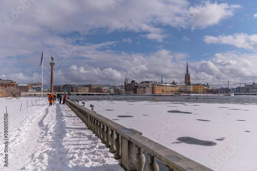 View from the Town City Hall parterre over the bay Riddarfjärden with ice floes and the old town islands, a grey day in Stockholm