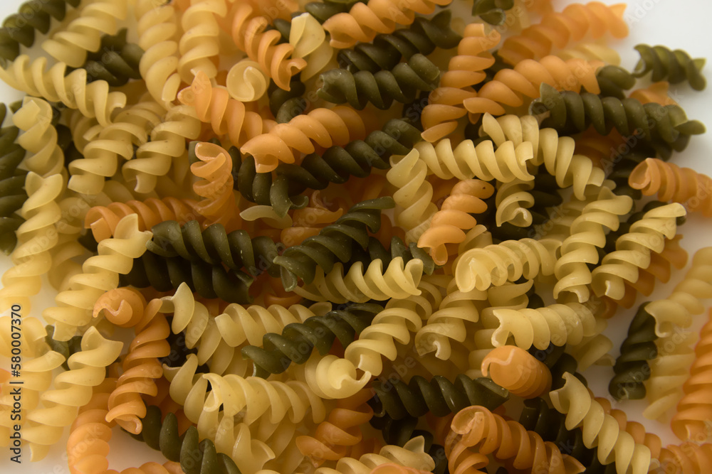 Close-up of a plate of Italian multicolored, green, yellow, orange fusilli pasta Close-up of a plate of Italian multicolored, green, yellow, orange fusilli pasta