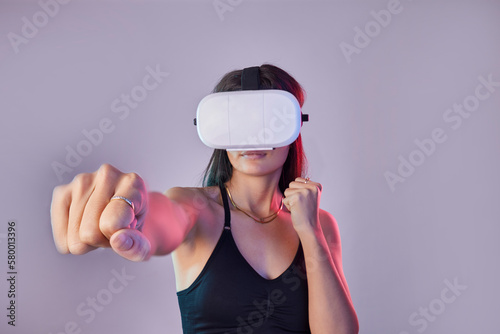 Vr, fitness and woman boxing in metaverse studio isolated on a purple background mockup. 3d exercise, virtual reality and female fighting or punching with futuristic technology for esports gaming.