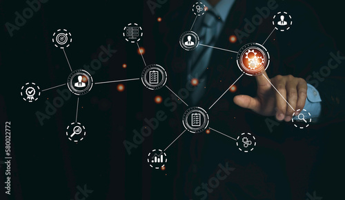 technology business, manager touching gears icons. operations system management involving business process and workflow, problem solving, monitoring and evaluation, quality control. high performance,