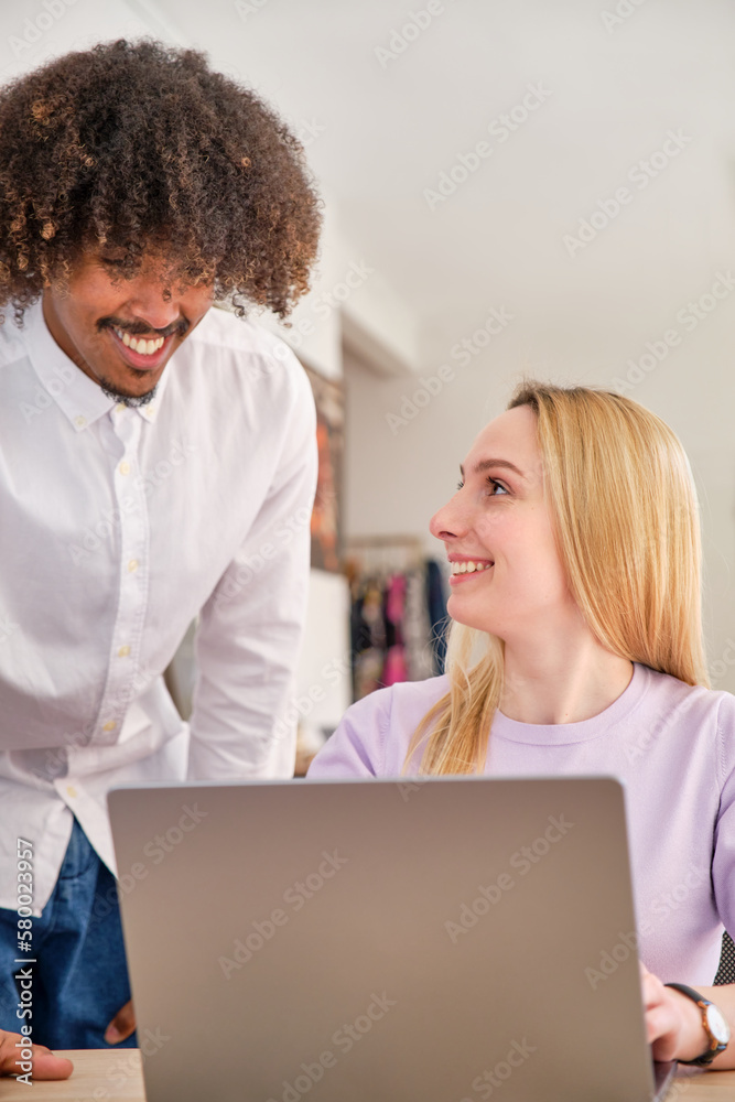 Coworking with African American young guy and blonde Caucasian young girl smiling Coworking with African American young guy and blonde Caucasian young girl smiling