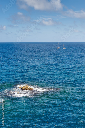 Photo of two beautiful sailboats crossing the open sea