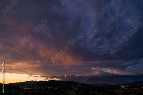 Dramatic landscape with view on evening city. Beautiful cloudy sky. © luengo_ua
