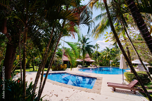 Tropical resort. Swimming pool and bungalow.