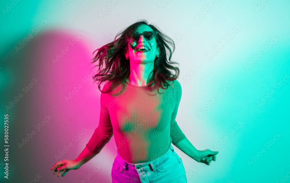 girl with sunglasses dancing in nightclub RGBW lights