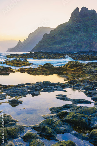 The rugged coastline of Punta del Hidalgo at sunrise. with the Anaga Mountains in the background, Tenerife, Canary Islands 