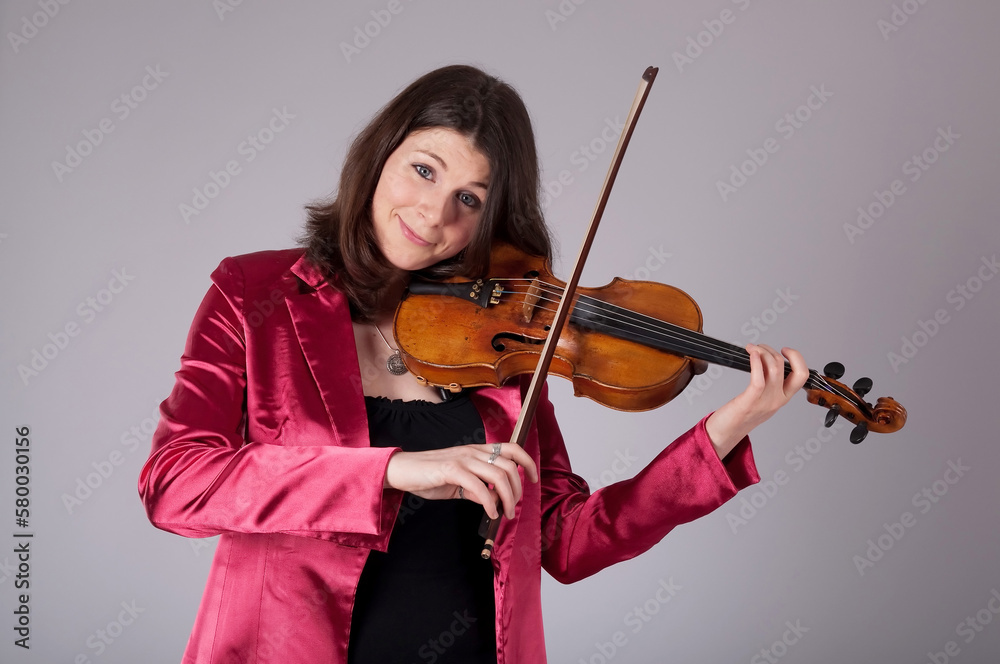 Girl, woman playing the violin in studio. Musician Girl, woman playing the violin in studio. Musician