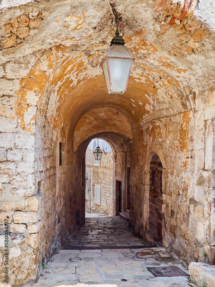 Charming passage, stone old archway in Dubrovnik Old Town. Croatia, Europe