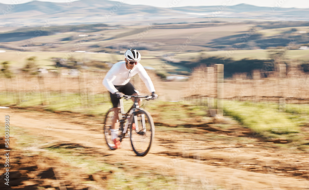 Man, bicycle and cycling with motion blur in nature, countryside and training for triathlon, sports and power. Cyclist, mountain bike and speed for off road travel, exercise or professional challenge Man, bicycle and cycling with motion blur in nature, countryside and training for triathlon, sports and power. Cyclist, mountain bike and speed for off road travel, exercise or professional challenge