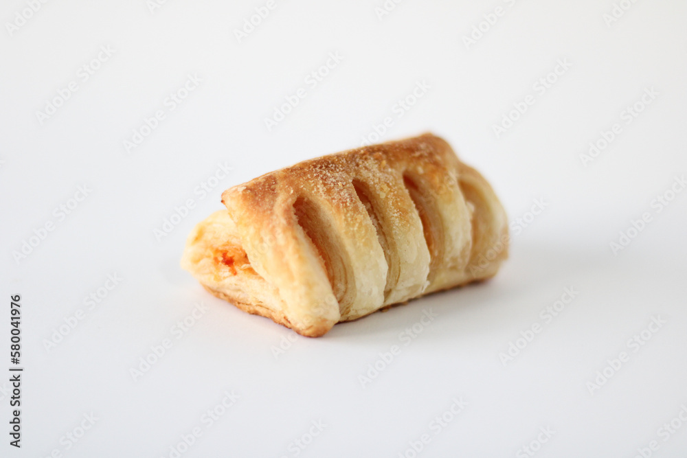 Bakery pastries with ham and cheese close-up. The concept of a delicious breakfast. Isolated over white background