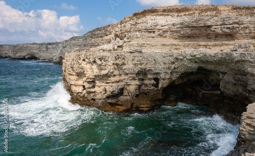 High limestone coastal cliffs against the backdrop of the Black Sea on Tarkhankut, Atlesh, western Crimea photo
