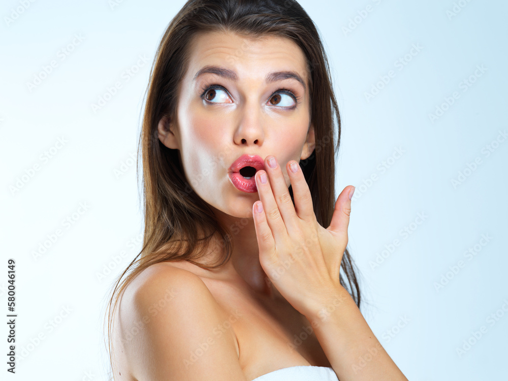 Wow, hand and woman surprised, shocked and omg expression for skincare results on blue background. Face, wtf and girl model with open mouth emoji for makeup, glamour and luxury cosmetic isolated Wow, hand and woman surprised, shocked and omg expression for skincare results on blue background. Face, wtf and girl model with open mouth emoji for makeup, glamour and luxury cosmetic isolated