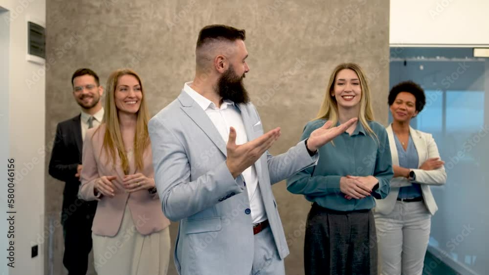 A successful group of business people in the modern office looking at the camera.
