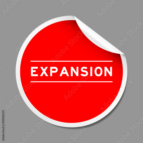 Red color peel sticker label with word expansion on gray background