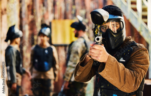 Paintball, focus or portrait of man with gun in shooting game playing in action battlefield mission. War, hero or focused soldier with army weapons gear in survival military challenge competition