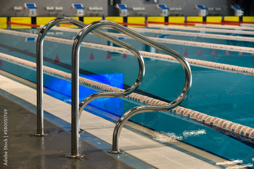 Swimming pool with dividing paths and handrails Swimming pool with dividing paths and handrails