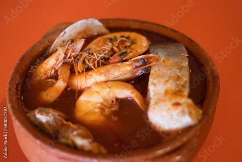 Caldo de pescado con camarones sin pelar  photo