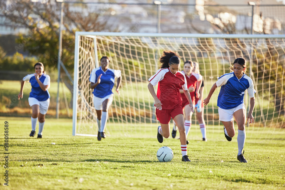Obraz premium Sports team, girl soccer and kick ball on field in a tournament. Football, competition and athletic female teen group play game on grass. Fit adolescents compete to win match at school championship.