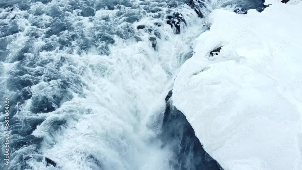 Dettifoss waterfall in Iceland, Frozen winter landscape with snow and ice aerial view 4k. Magical nature winter location with pure glacial water and huge current. Famous tourist attraction. Dettifoss waterfall in Iceland, Frozen winter landscape with snow and ice aerial view 4k. Magical nature winter location with pure glacial water and huge current. Famous tourist attraction.