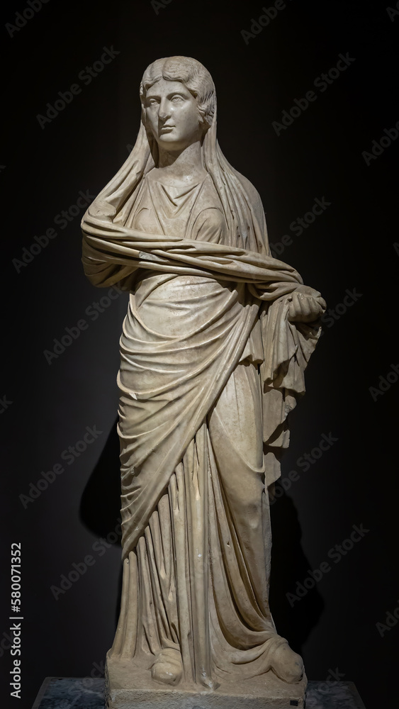 Woman marble statue from ancient Perge city. Statue of Roman aristocratic woman (Plancia Magna) in traditional dress. Antalya, Turkey.