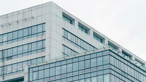 Skyscraper glass facade. Office exterior. Details of complex high rise building. Financial district. Glass facade building Tech industry