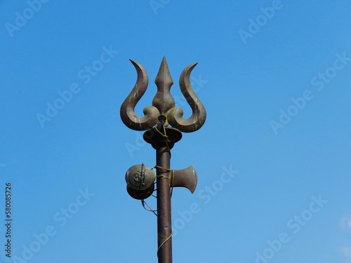 Trident weapon, and ornaments of Lord Shiva. Weapon of God Shiva. Trishul and damaru drum. photo