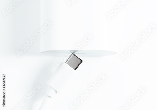 Charger and USB Type-C cable on white background photo