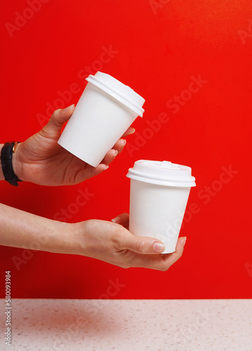 Paper cup mockup psd with hand and logo placement