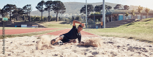 Athlete long jump, sand and sports man training for France olympic competition, workout challenge or fitness exercise. Winner mindset, commitment and athletics person working on leg power performance photo
