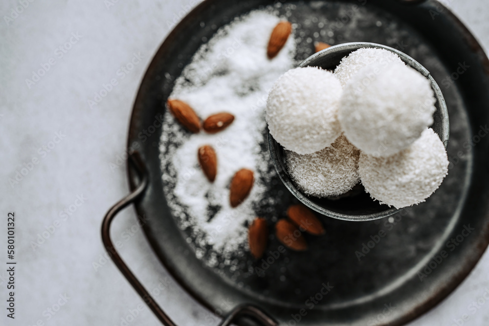 Beautiful and delicious homemade coconut flakes truffles with almonds and nuts in a retro grunge style. Beautiful and delicious homemade coconut flakes truffles with almonds and nuts in a retro grunge style.