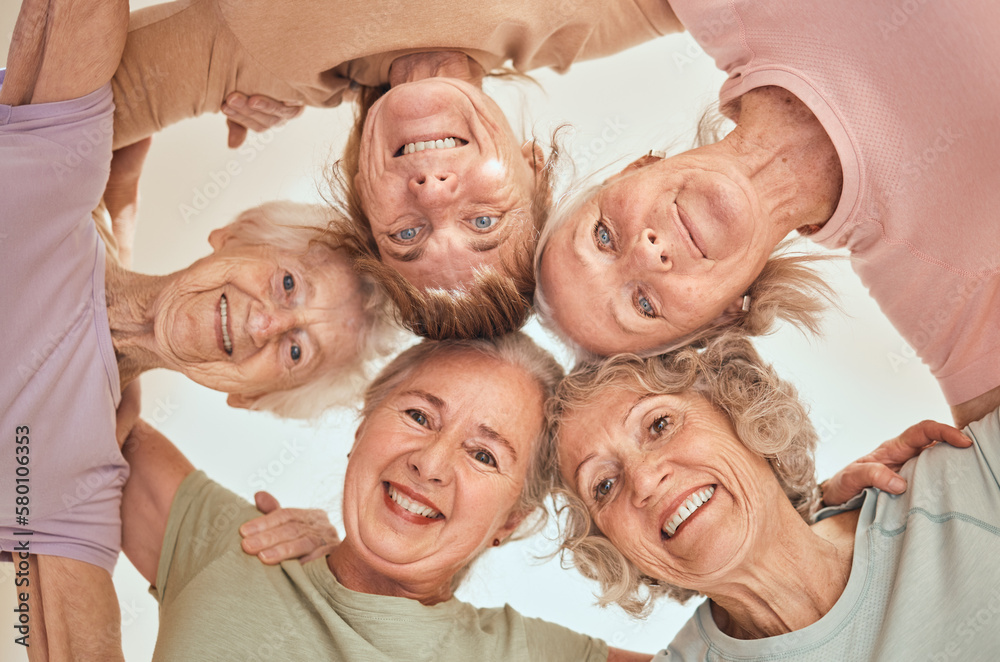 Fitness, happy and elderly friends in a circle for support, trust and team building in a wellness class below view. Partnership, smile and senior women in a huddle with motivation, health or hope