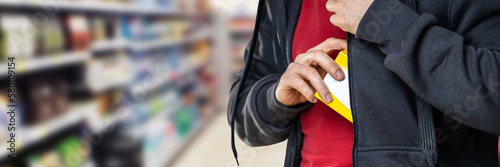 Retail Shoplifting. Man Stealing In Supermarket photo