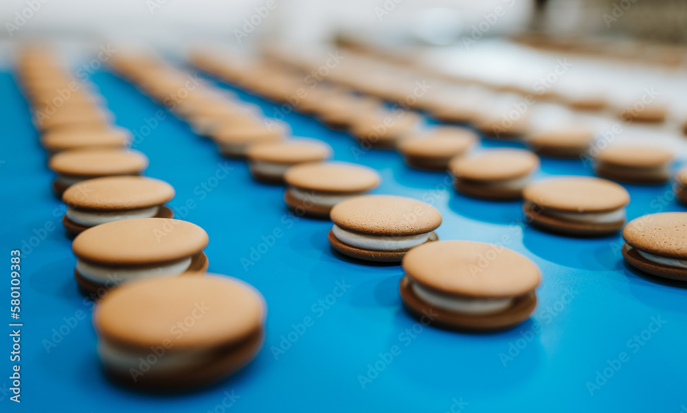 Huge factory line for sweet food and cookies production. Close up shots of industrial manufacturing process. Huge factory line for sweet food and cookies production. Close up shots of industrial manufacturing process.